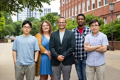 five people posing for a picture