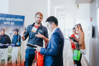 Student speaking to a recruiter at a career fair