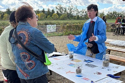 Student speaks to visitors at Dragon Expo