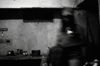 A person sits in a kitchen