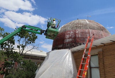 Person working on dome restoration