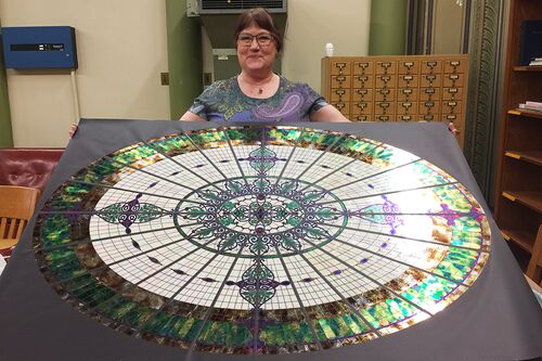 Jane Bergman and her replica of Altgeld Hall's former glass dome