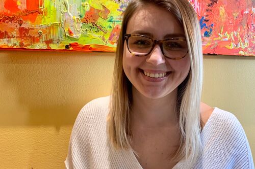 LAS sophomore Angie Orzel poses for a photo in front of a colorful background