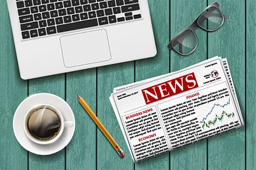 Photo illustration of computer, newspaper, and coffee