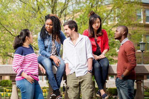 Students speaking outside on campus