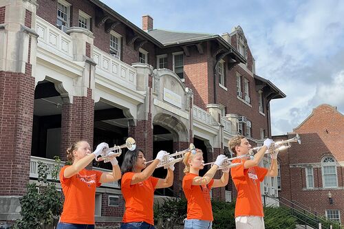 Members of the Marching Illini pose in front of Illini Hall