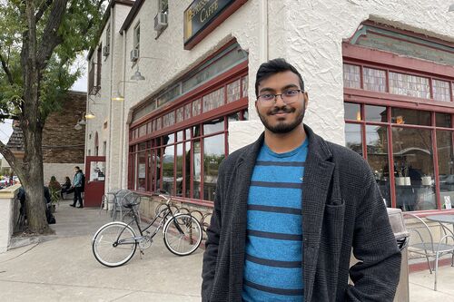 Sanketh Bhaskar smiles outside Espresso Royale