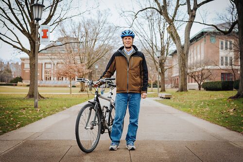 Dave Tewskbury with his bicycle on the Main Quad