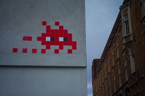 Space invaders art on a wall 