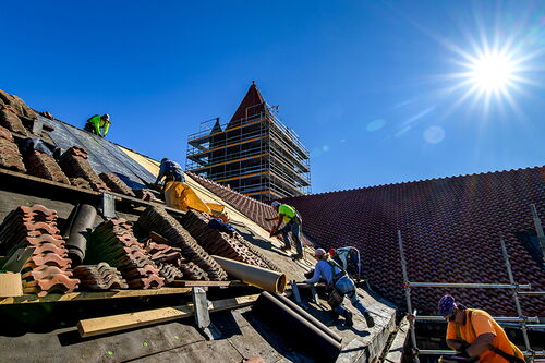 Workers renovate the roof of Altgeld Hall
