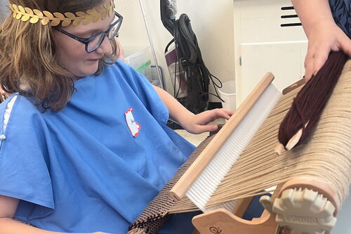 Camper working a Roman loom