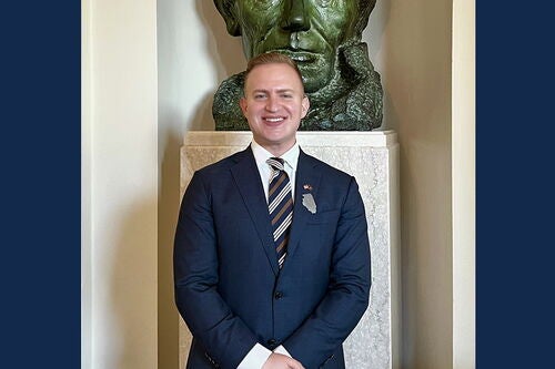 Adham Sahloul stands in front of a bust of Abraham Lincoln