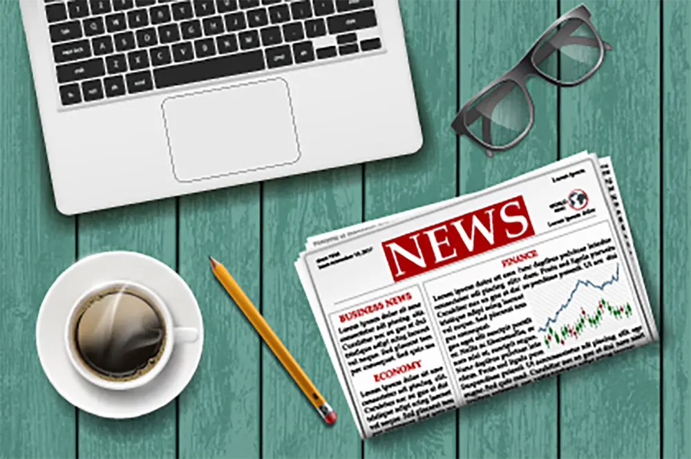 Photo illustration of computer, newspaper, and coffee