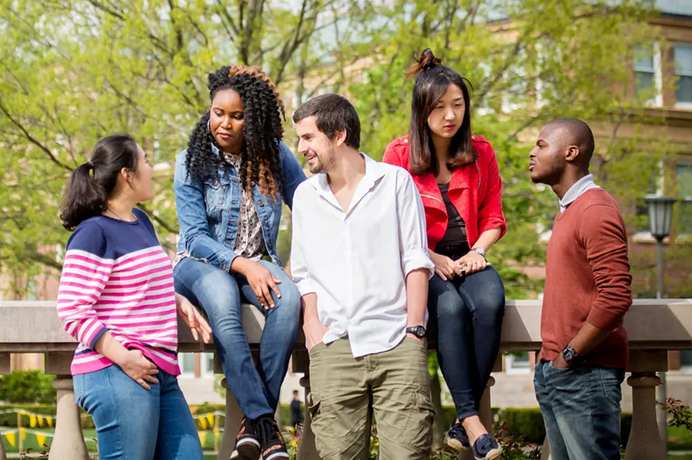 Students speaking outside on campus
