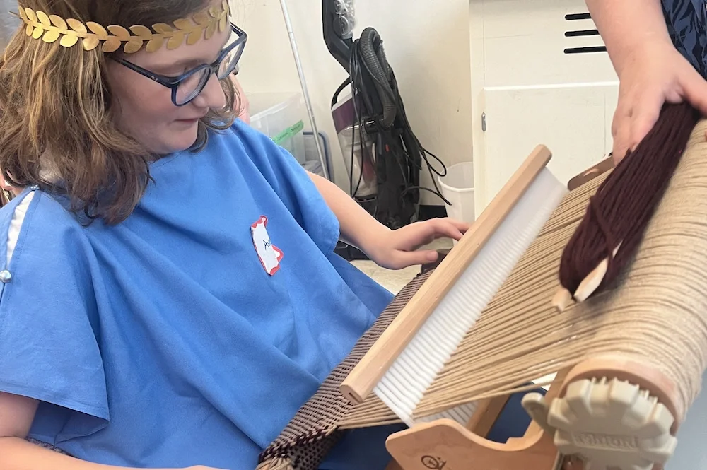Camper working a Roman loom