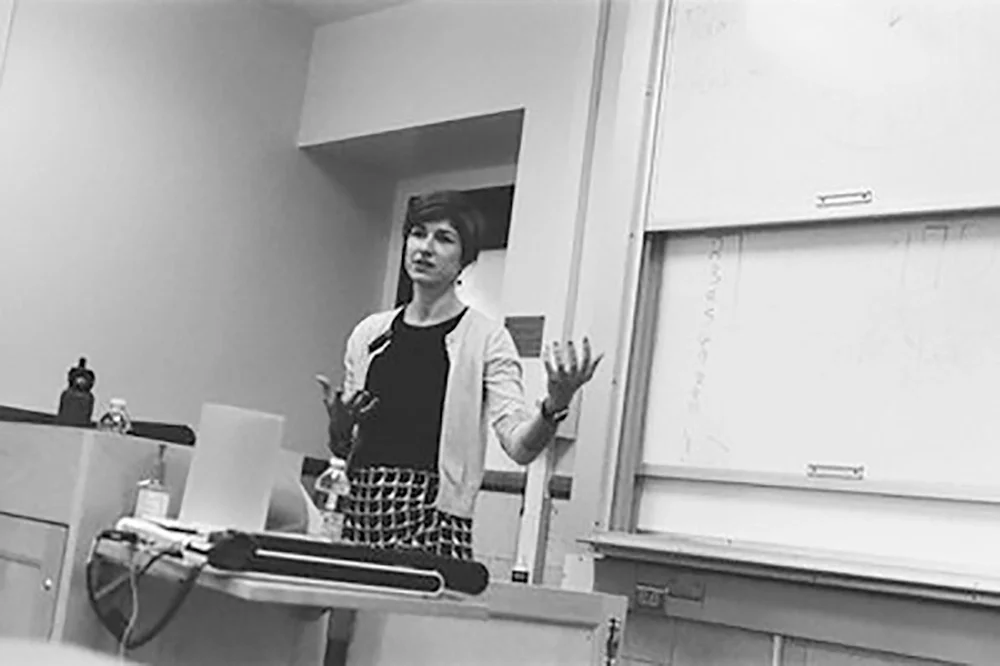Verena Erlenbusch-Anderson speaking at the front of a classroom