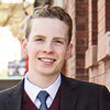 LAS student poses for photo in black suit and blue tie