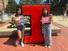 Ariana and her older sister in front of a Block-I with signs reading "Fall 2024" and "First Day of Class". 