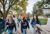 Students in Illinois gear walking down the Main Quad. 