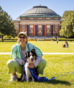 student with dog on main quad