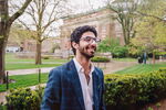 Illinois student in business casual attire standing near Foellinger Auditorium