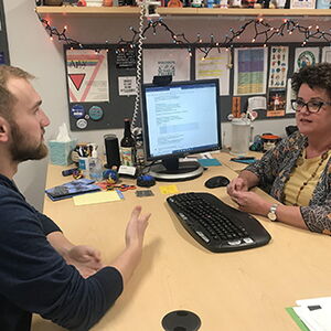 Jennifer Brandyberry, advisor for the School of Molecular and Cellular Biology, visits with a student during registration for the Spring 2020 semester.
