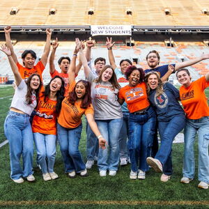 students standing in the middle of Memorial Stadium in Illini gear