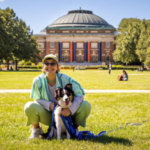 student with dog on main quad